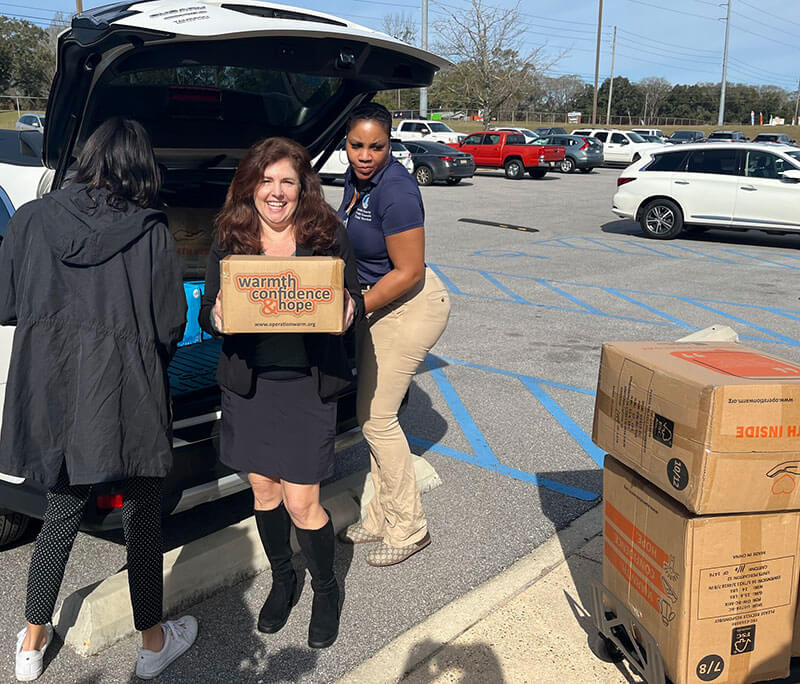 volunteers bringing boxes of donations inside