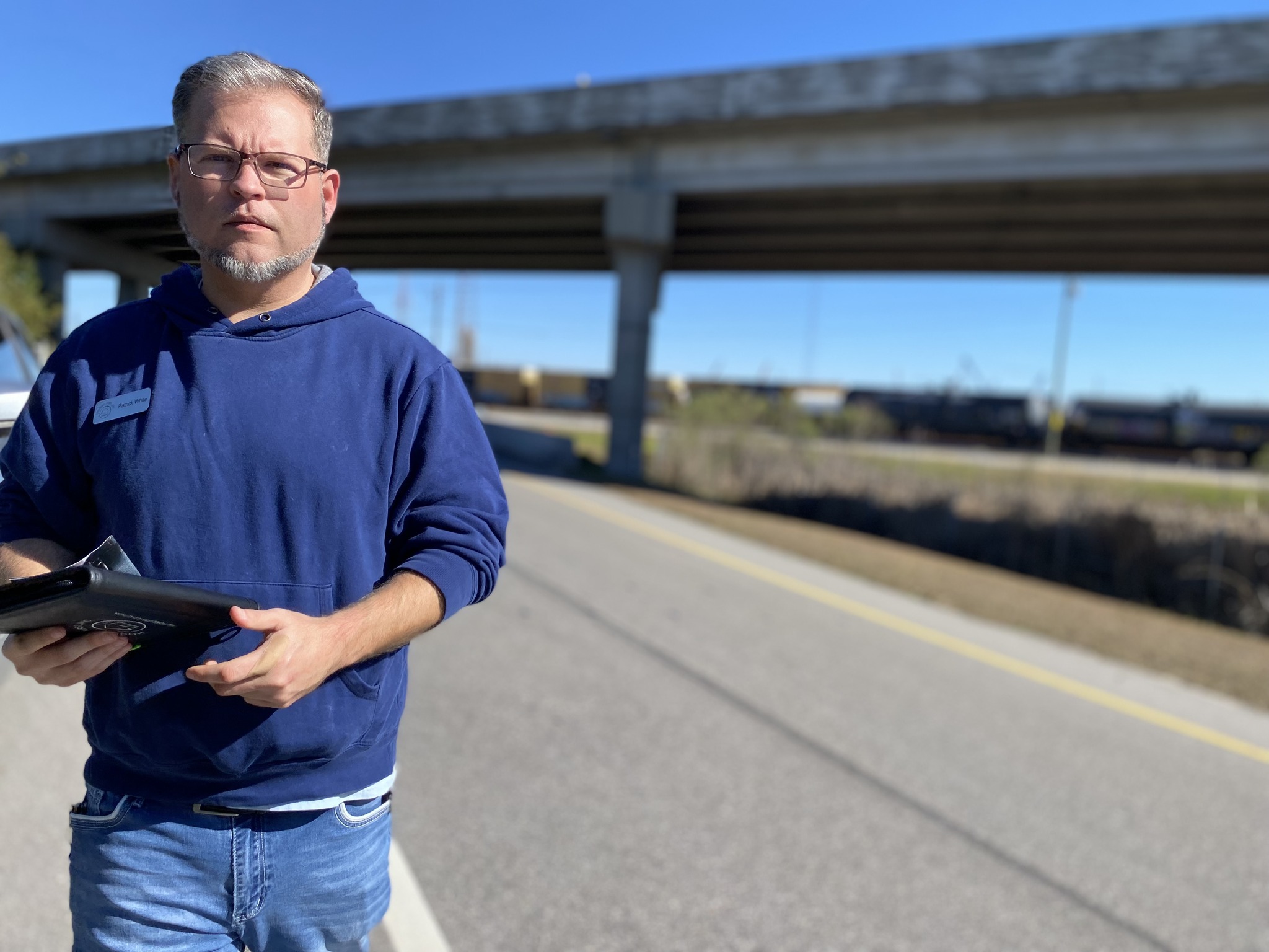 man walking near a freeway