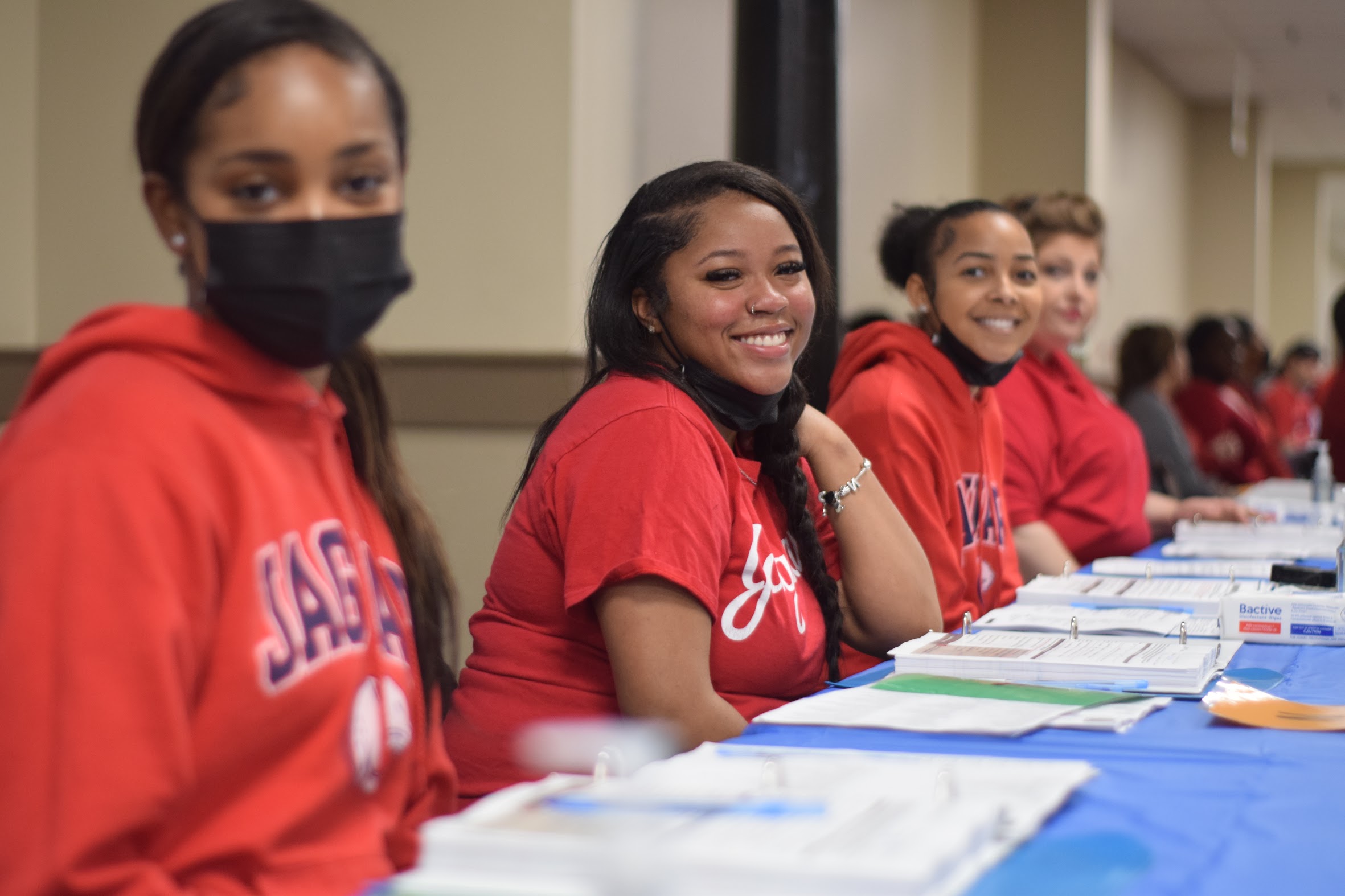 Smiling volunteers sitting at a table
